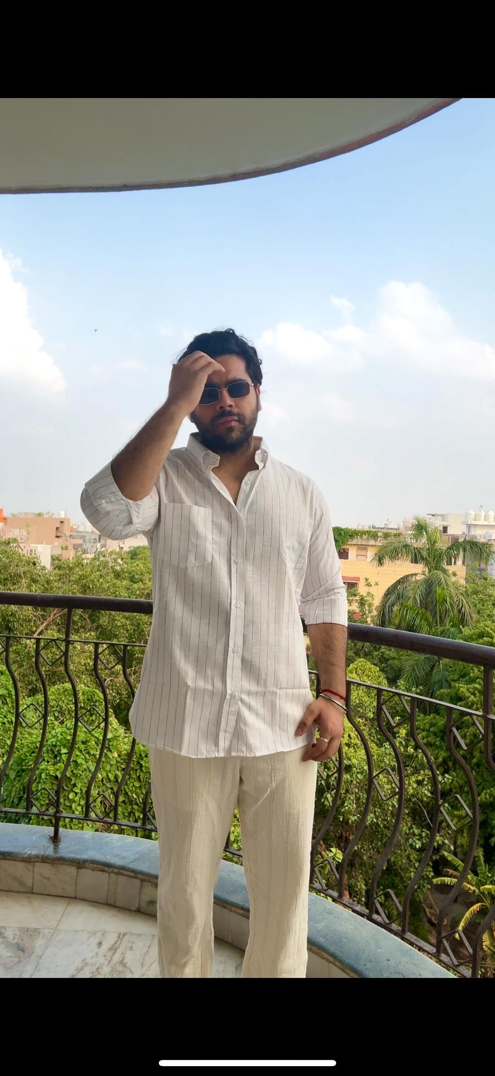 Archit wearing the Dignity Black Chalk Stripe Shirt